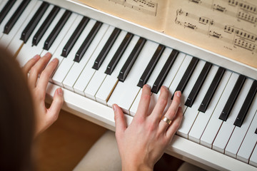 Fototapeta na wymiar Playing Piano (shallow DOF; color toned image)