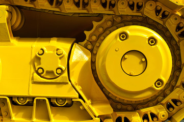 Track drive gear, bulldozer sprocket mechanism, large yellow construction machine with bolts, heavy...