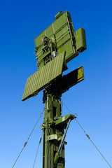 Air defense radar of military mobile antiaircraft system in green color, modern army industry, blue...