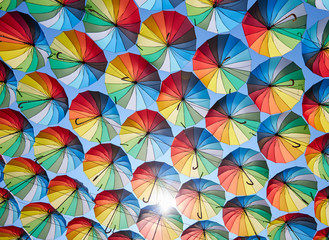 Fototapeta na wymiar Colorful umbrellas hanging over the city streets