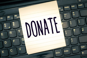 Writing note showing Donate. Business photo showcasing give money or goods for good cause for...