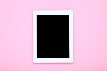 Tablet computer on pink background
