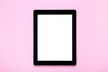 Tablet computer on pink background