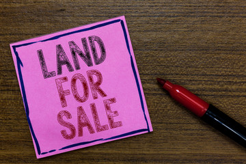 Text sign showing Land For Sale. Conceptual photo Real Estate Lot Selling Developers Realtors Investment Purple Paper Important reminder Communicate ideas Marker Wooden background