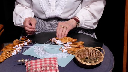 Old grandmother lace making in the city. Black isolated background. Brussels, Belgium