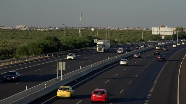 4K. Ultra HD. Aerial view of vehicles traveling the road under the afternoon light. Safe driving on the road. Engravings in the round trip. Holidays.