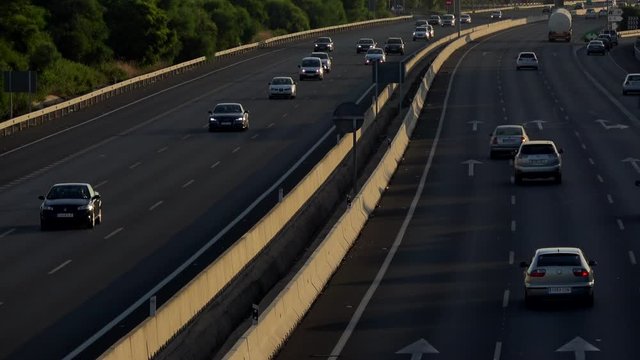 4K. Ultra HD. Aerial view of vehicles traveling the road under the afternoon light. Safe driving on the road. Engravings in the round trip. Holidays.