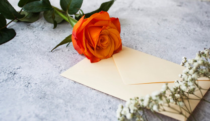 Close up view of a beautiful rose and a letter