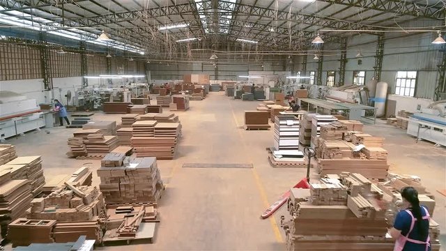 Manufacture of furniture from wood boards and MDF. Assembly of furniture at a furniture factory in China. Workshop work in a furniture factory.