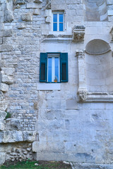 Blue window in a stone wall