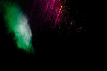 Abstract colorful powder explosion on black background.Freeze motion of dust splash.Painted Holi.