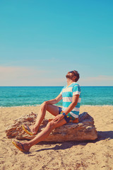 Fototapeta na wymiar Attractive man enjoying on the tropical beach. Summer concept.