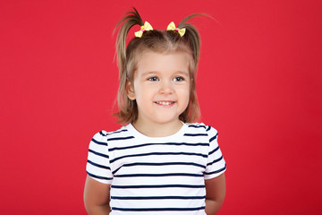 Cute little girl on red background