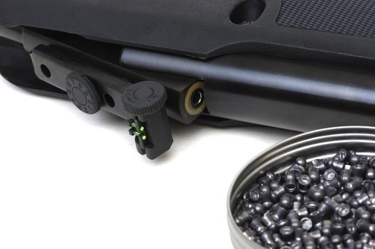 Black air rifle gun on a white