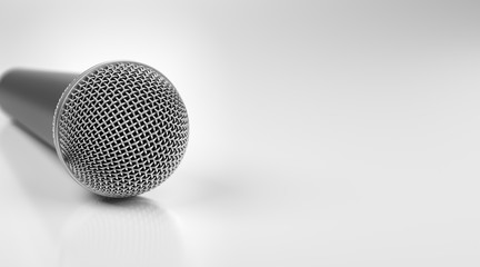 Macro shot of microphone on white glossy table with dof effect.