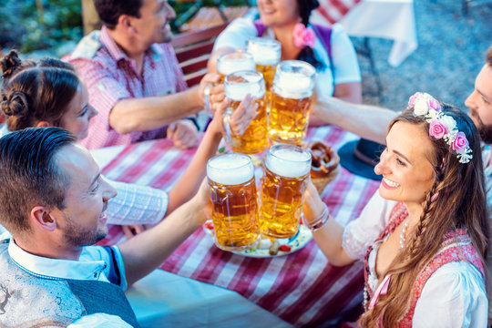 People enjoying food and drink in Bavarian beer garden