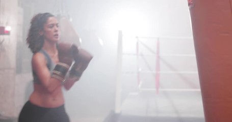 Female exercising with a a punch bag