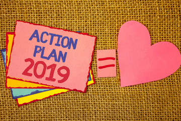 Writing note showing Action Plan 2019. Business photo showcasing Challenge Ideas Goals for New Year Motivation to Start Pink yellow blue notes black red letters ideas equal sign heart wicker