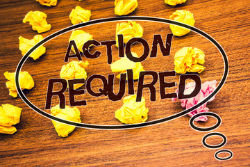 Word writing text Action Required. Business concept for Important Act Needed Immediate Quick Important Task Text wood desk crumbled paper notes yellow pink stress studying school