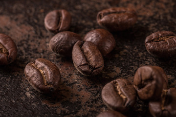 Coffee beans  on stone background. Top view with copy space for your text. Roasted coffee beans background. Beans texture, macro