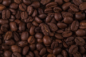 Coffee beans  on stone background. Top view with copy space for your text. Roasted coffee beans background. Beans texture, macro