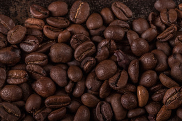 Coffee beans  on stone background. Top view with copy space for your text. Roasted coffee beans background. Beans texture, macro