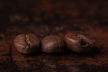 Coffee beans  on stone background. Top view with copy space for your text. Roasted coffee beans background. Beans texture, macro