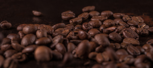 Coffee beans  on stone background. Top view with copy space for your text. Roasted coffee beans background. Beans texture, macro