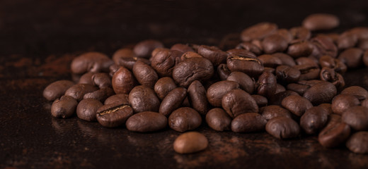 Coffee beans  on stone background. Top view with copy space for your text. Roasted coffee beans background. Beans texture, macro