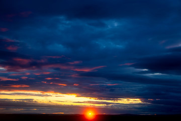 Unrealistic colorful sunset in the lush clouds in Iceland