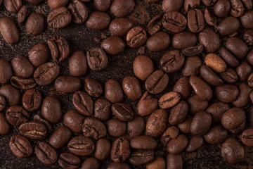 Coffee beans  on stone background. Top view with copy space for your text. Roasted coffee beans background. Beans texture, macro