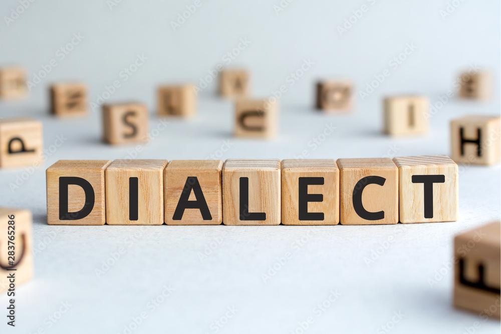 Aufkleber dialect - word from wooden blocks with letters, form of a language dialect concept, random letters a