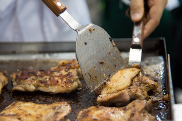 chef cooking Grilled chicken, Teppanyaki in restaurant