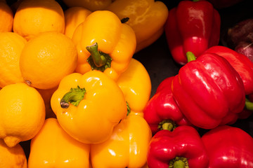 Fresh colorful yellow, orange and red bell peppers for sale at local supermarket.