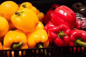 Fresh colorful yellow, orange and red bell peppers for sale at local supermarket.