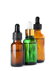 Obraz na płótnie Canvas Bottles of herbal essential oils isolated on white