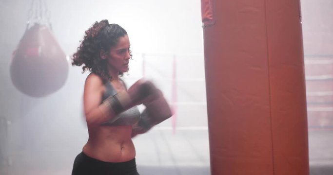 Female exercising with a a punch bag