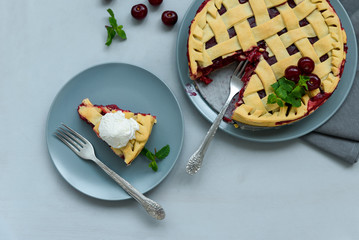 Homemade cherry lattice cake on gray wooden background. Traditional american food. Top view