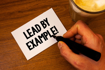 Conceptual hand writing showing Lead By Example Motivational Call. Business photo text Leadership Management Mentor Organization Text white paper hand black marker coffee glass letter