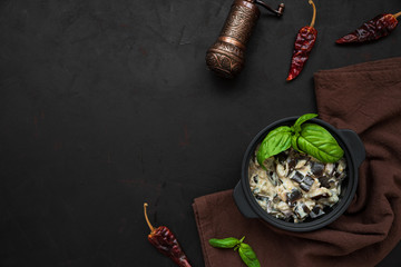 Eggplant curry on dark wooden background. Top view. Copy space. Healthy food concept