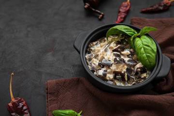Eggplant curry on dark wooden background. Healthy food concept