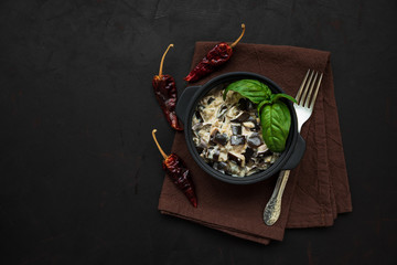 Eggplant curry on dark wooden background. Top view. Copy space. Healthy food concept