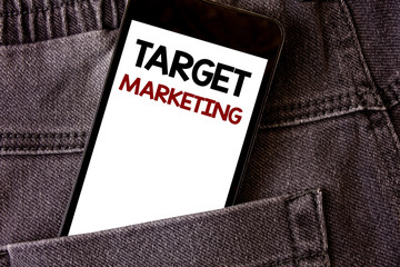 Writing note showing Target Marketing. Business photo showcasing Market Segmentation Audience Targeting Customer Selection Words written black Phone white Screen Back pocket grey jeans trousers