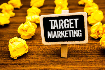 Handwriting text writing Target Marketing. Concept meaning Market Segmentation Audience Targeting Customer Selection White text black paint wooden board clip desk yellow paper notes warning