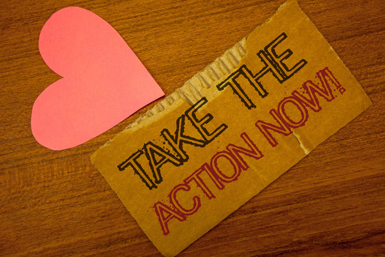 Text sign showing Take The Action Now Motivational Call. Conceptual photo Act Start Promptly Immediate Instantly Peru color torn page with engraved black red text woody desk pink heart