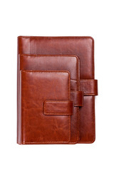 Stack of brown leather notebook on a white