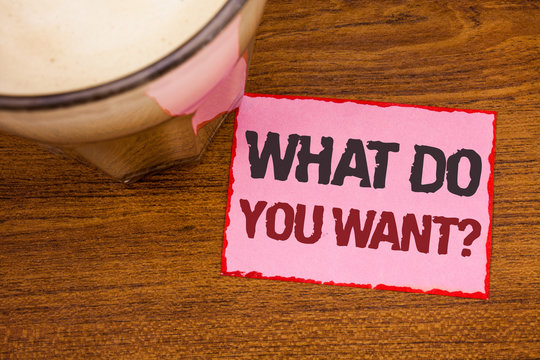 Conceptual hand writing showing What Do You Want Question. Business photo text Aspiration Contemplation Need Contemplate Aspire Wooden desktop red lined pink paper with several texts coffee mug