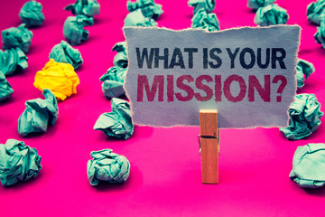 Writing note showing What Is You Mission Question. Business photo showcasing asking someone about his plans and to-do list Emerald paper balls yellow lump rosy floor paperclip retain grey page