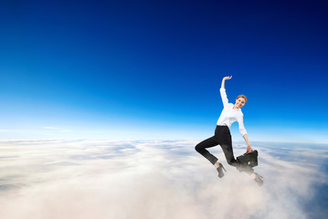 Young businesswoman in formal wear flying in blue sky.
