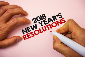 Writing note showing 2018 New Year'S Resolutions. Business photo showcasing List of goals or targets to be achieved Marker pen paper Ideas messages remember information important pink